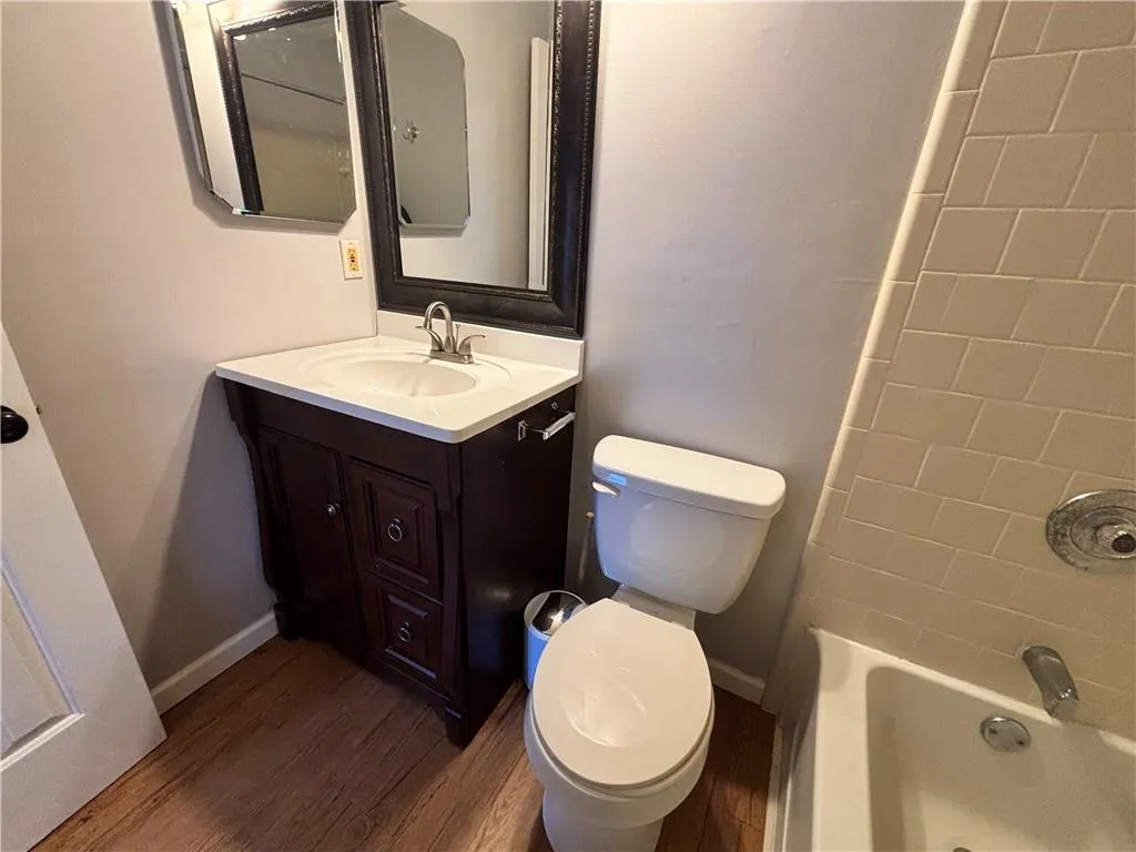 Wood vanity and toilet in secondary bedroom
