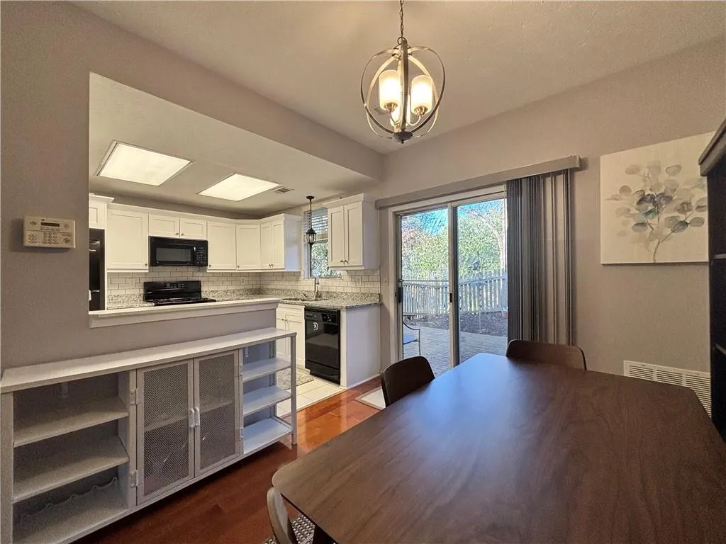 Dining room view into the kitchen and patio doors to backyard
