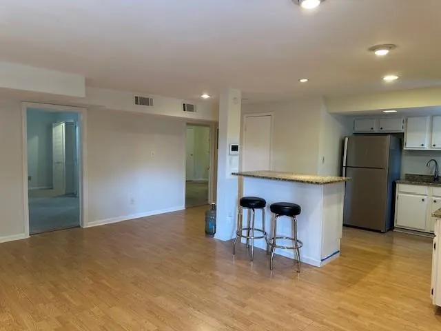 The bedroom is off to the left and the bonus room is to the right. The bathroom is behind the closed door.