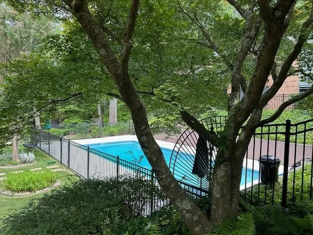 Lovely landscaping and wrought iron enclosure