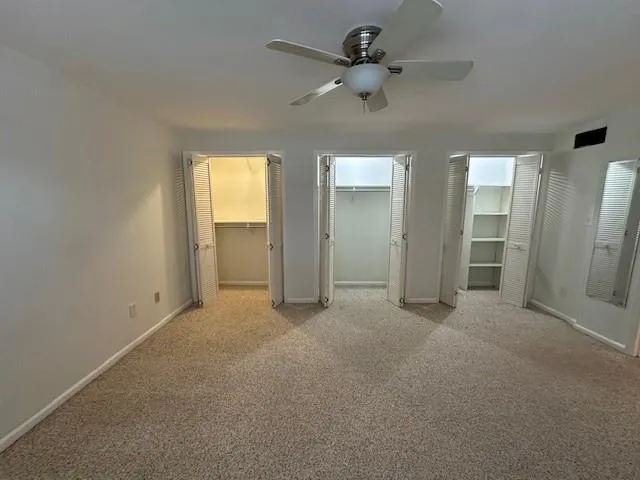 The wall of closets in the primary bedroom provides lots of space.