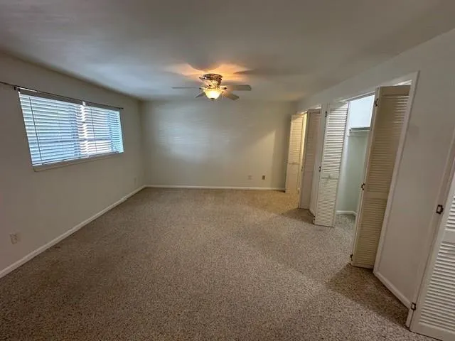 The bedroom is spacious and has a wall of closets!