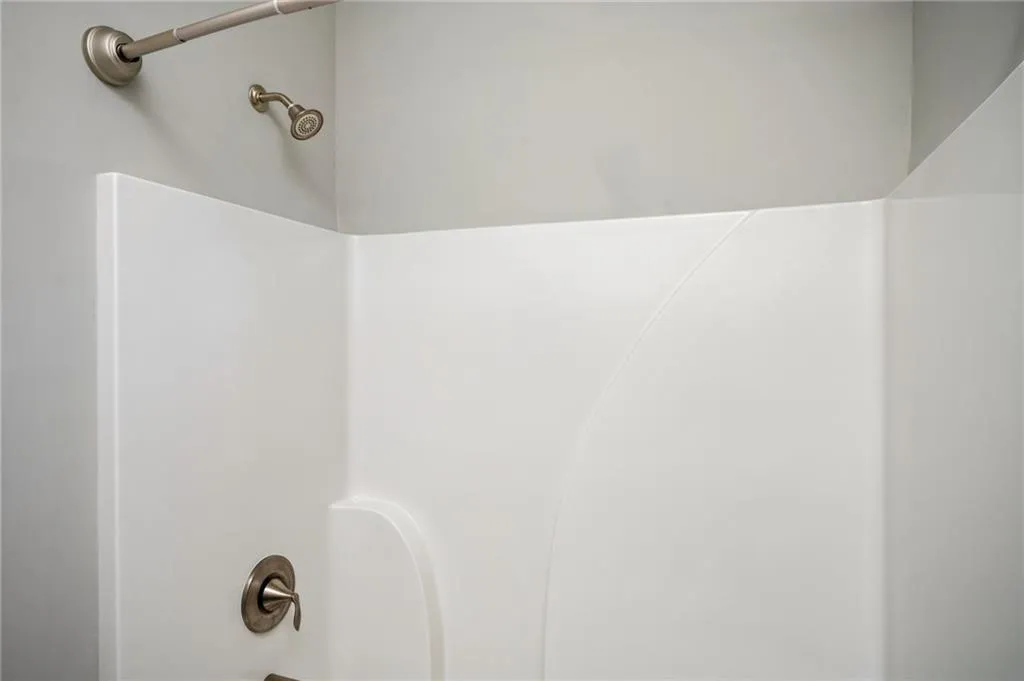 Bathroom view of bathing tub / shower combination