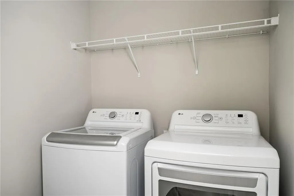 Washroom featuring washing machine and dryer