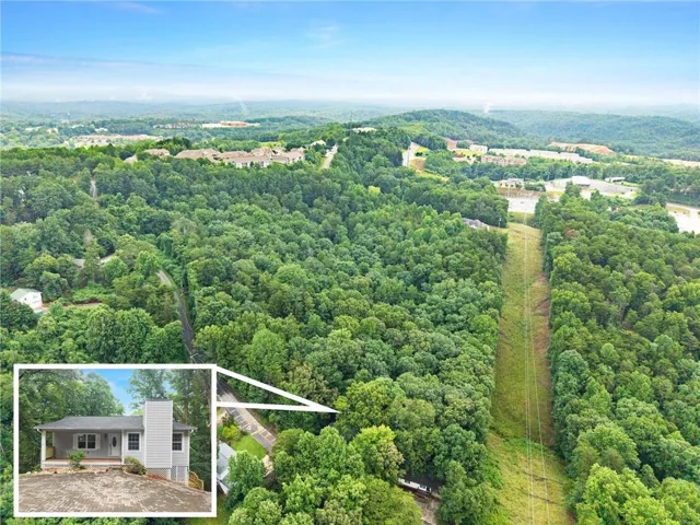 Aerial perspective showcasing a property surrounded by extensive natural foliage