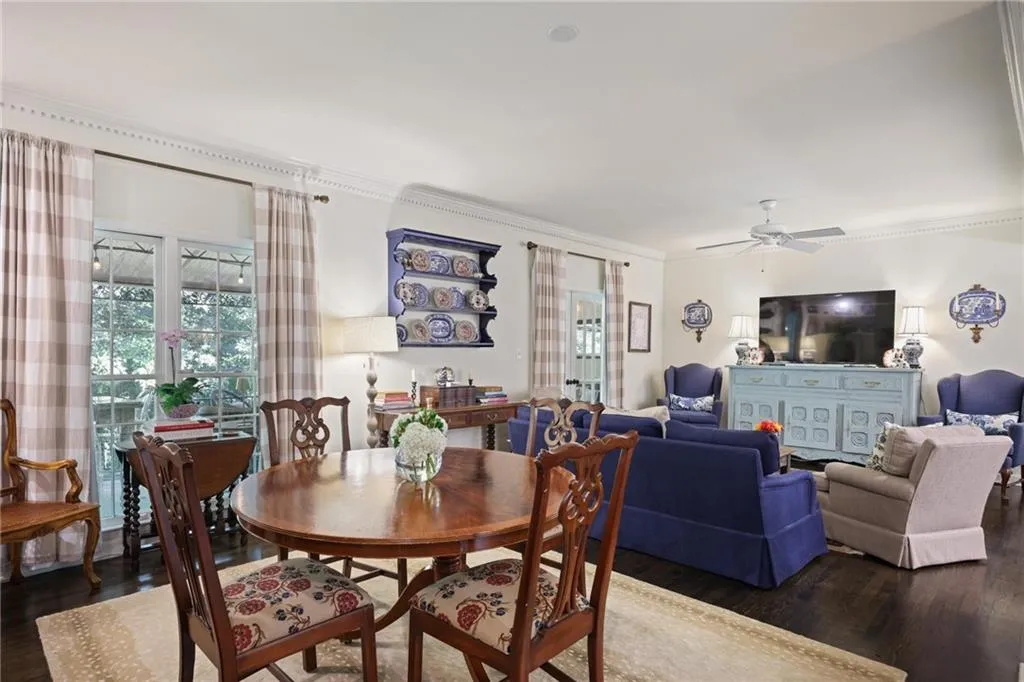 Dark wood-finish flooring, white walls, and decorative crown molding