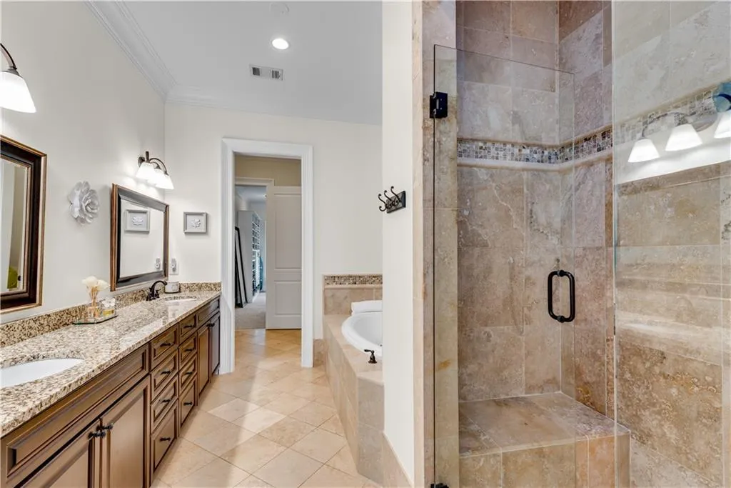 Bathroom featuring vanity, tile patterned floors, independent shower and bath, and ornamental molding