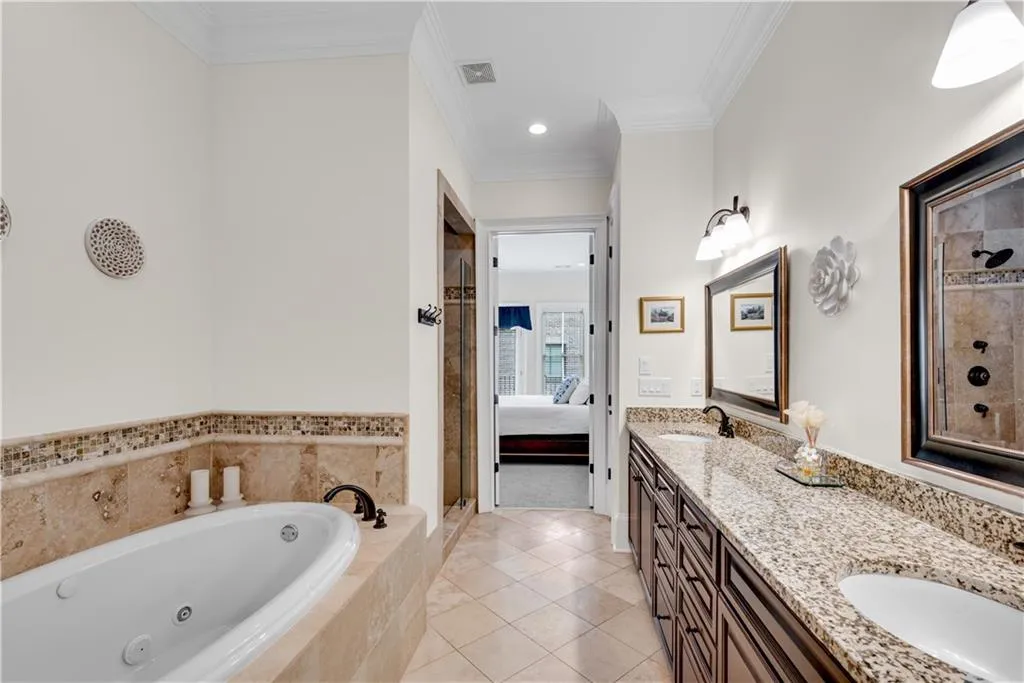 Bathroom featuring vanity, ornamental molding, separate shower and tub, and tile patterned flooring
