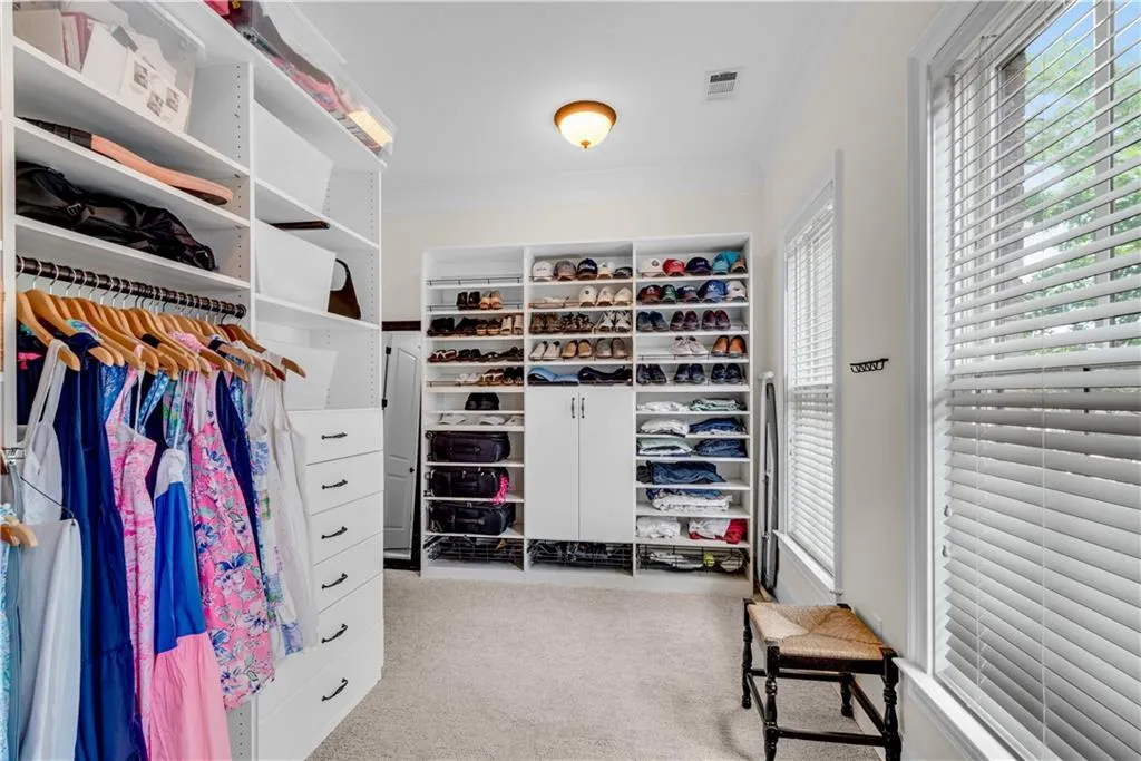 Spacious closet with light colored carpet