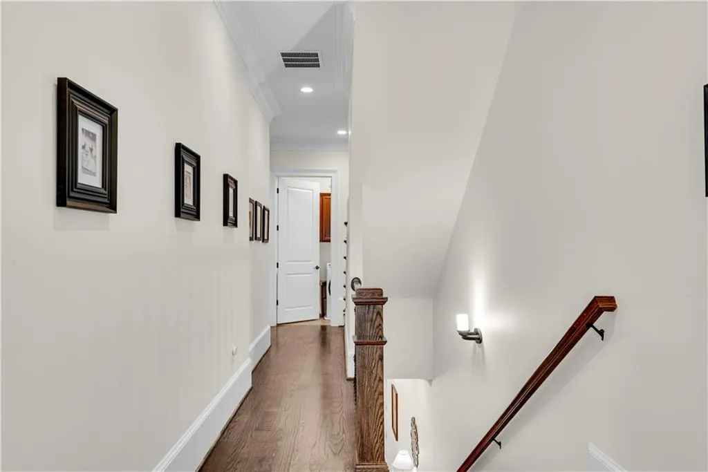 Hallway featuring crown molding and hardwood / wood-style flooring