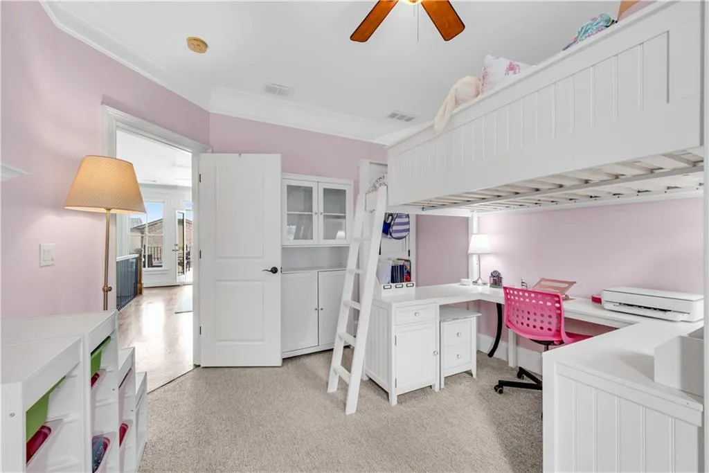 Home office with built in desk and ceiling fan