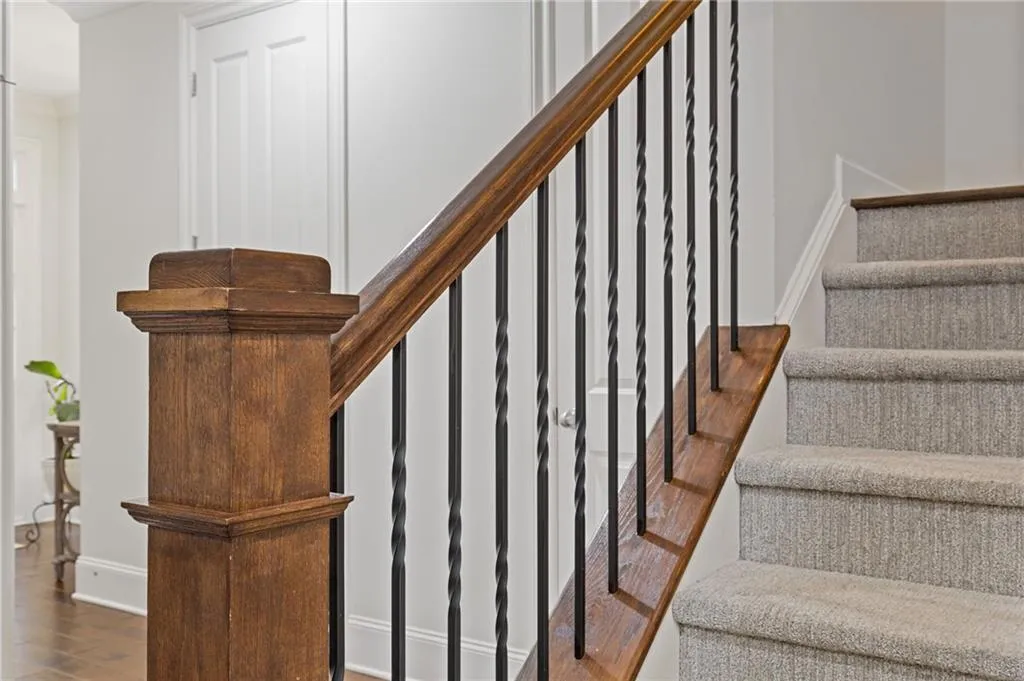 Iron stair rails and recently installed luxury carpet