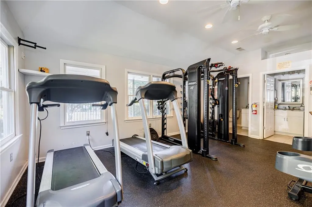 Workout area with recessed lighting, a ceiling fan, and vaulted ceiling