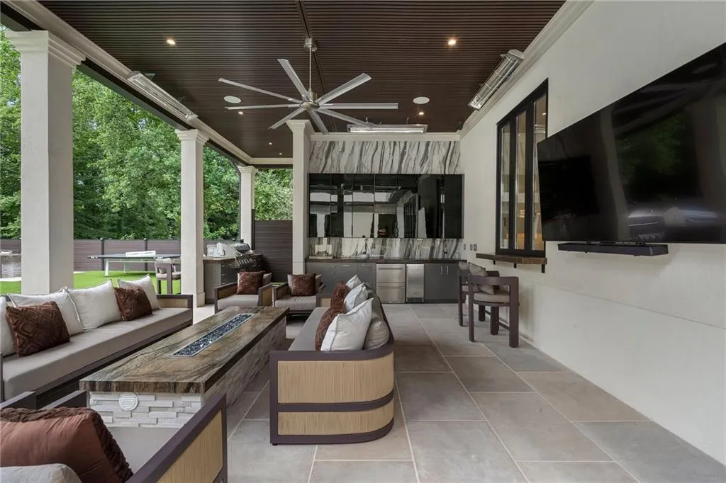 Covered patio with pool bath, shower, outdoor kitchen, linear fire table and patio heaters
