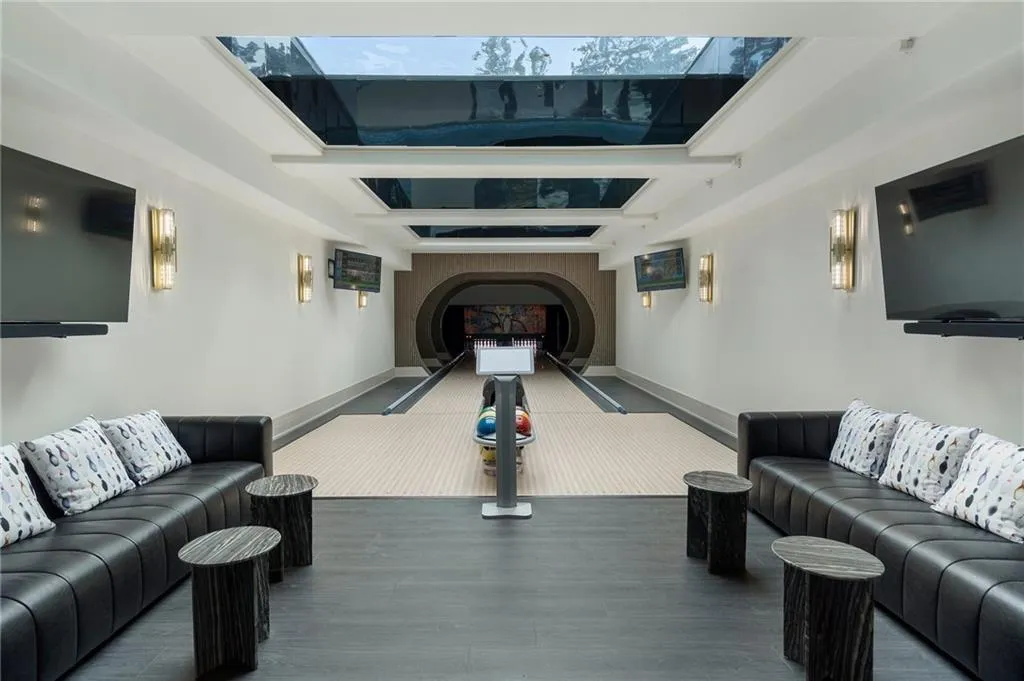 Two 50' bowling alley lanes with glass bottom swimming pool above