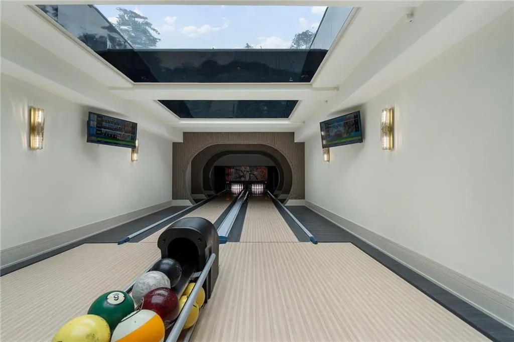 Two 50' bowling alley lanes with glass bottom swimming pool above