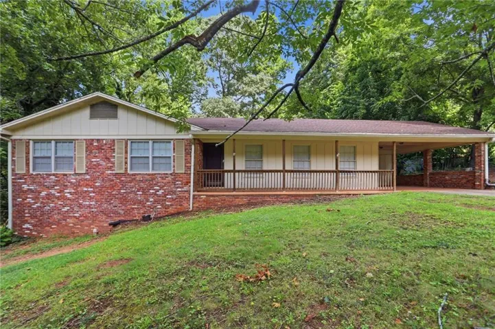 Brick exterior with white siding accents and a covered front porch