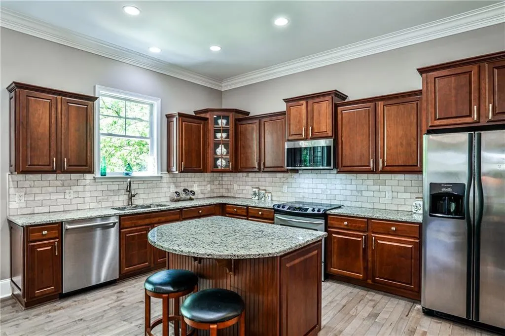 Outfitted with sleek stainless steel appliances, this kitchen combines modern functionality with a polished, upscale look