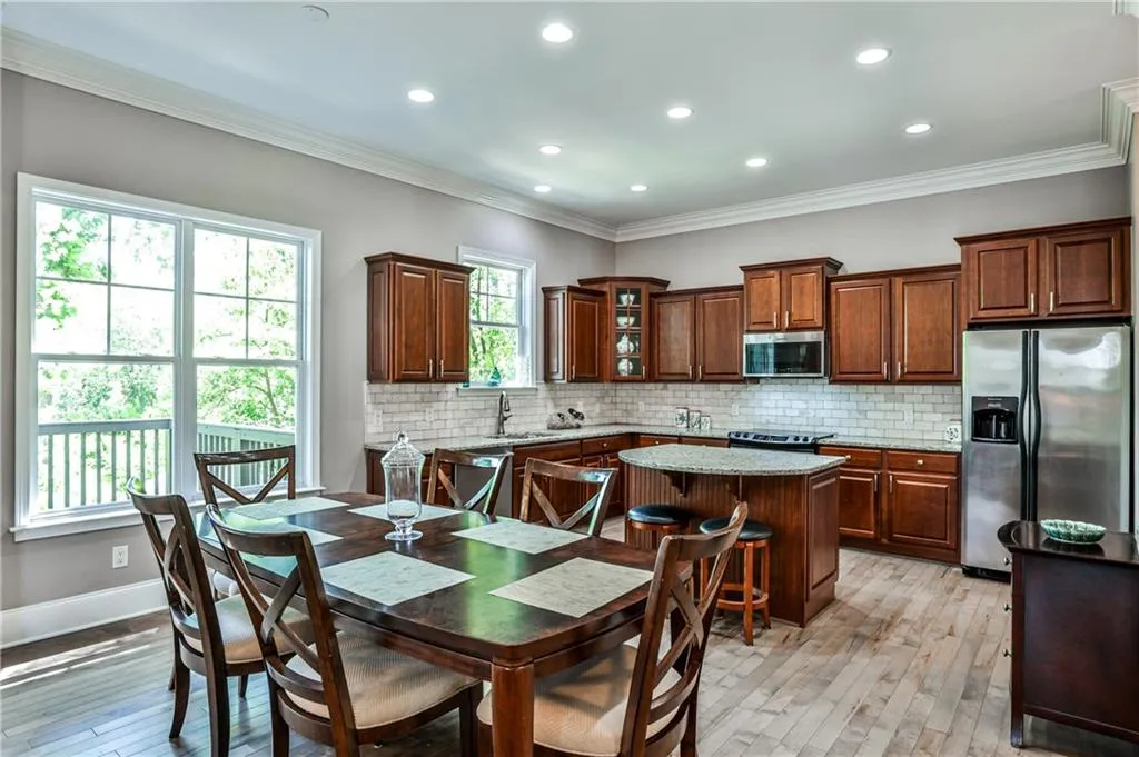 Featuring elegant, rich wood cabinetry that offers both timeless style and ample storage, this kitchen blends warmth and sophistication