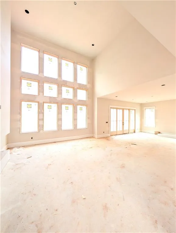 Empty room with french doors and a high ceiling