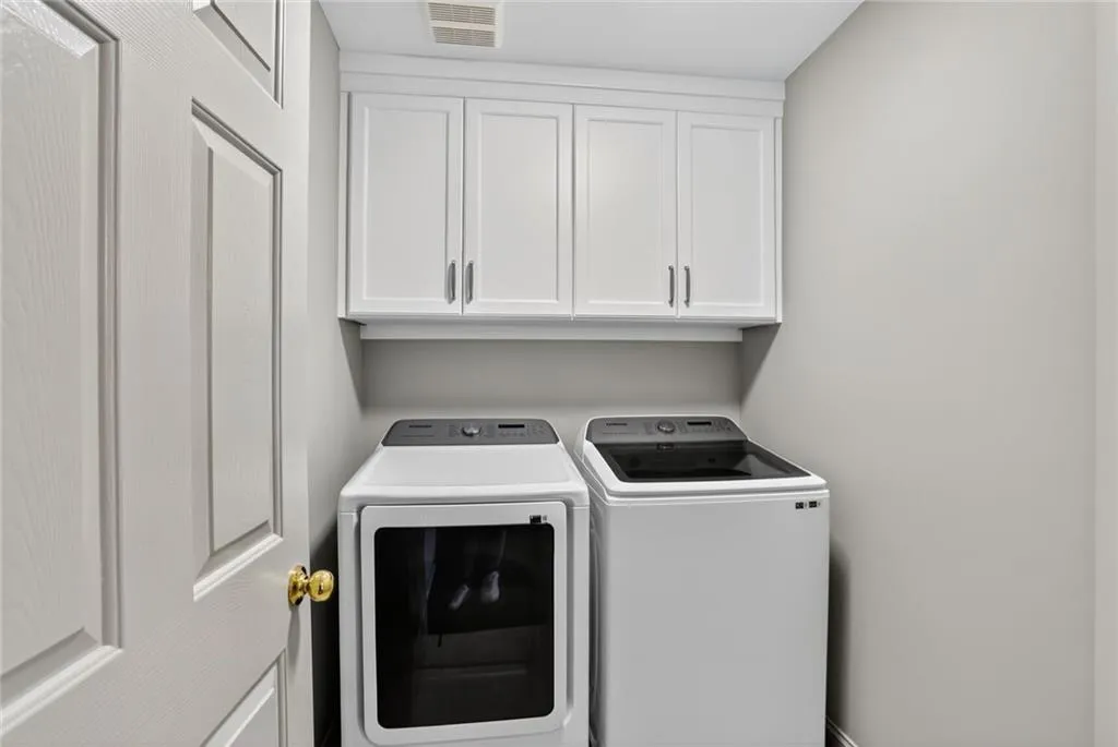 You'll love the large laundry room with added cabinets - located on the terrace level.