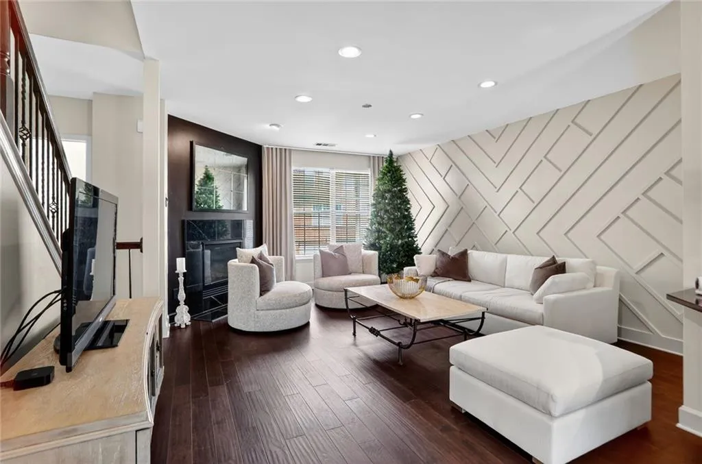 On the main level the lovely hardwoods continue - this family room richly appointed with a tiled fireplace and feature wall.