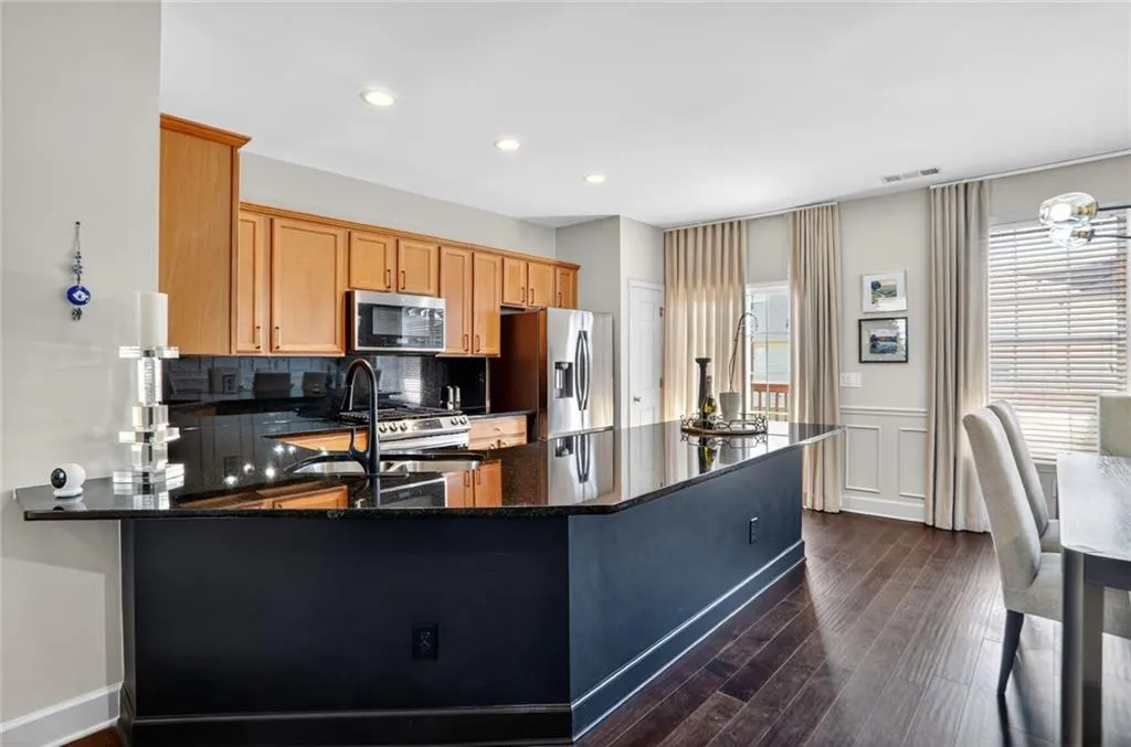 This stunning kitchen with granite countertops, stainless appliances - plenty of room to add barstools. The large pantry has custom shelving also.