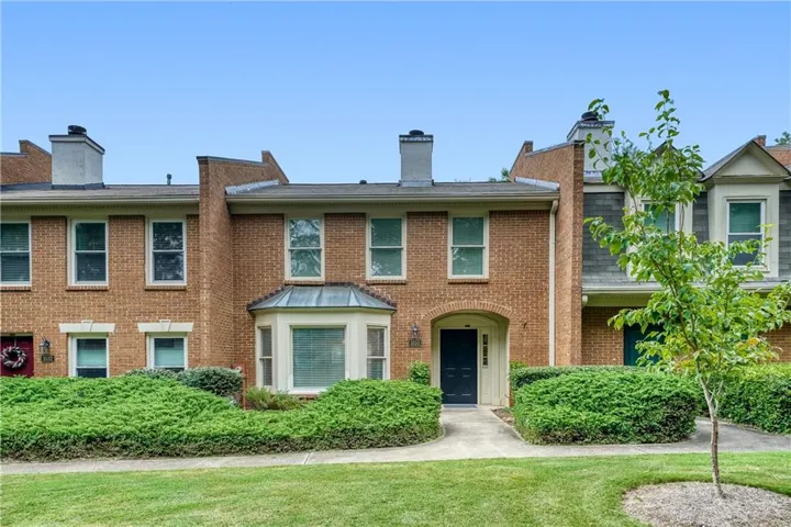 Brick exterior with a bay window and arched entryway