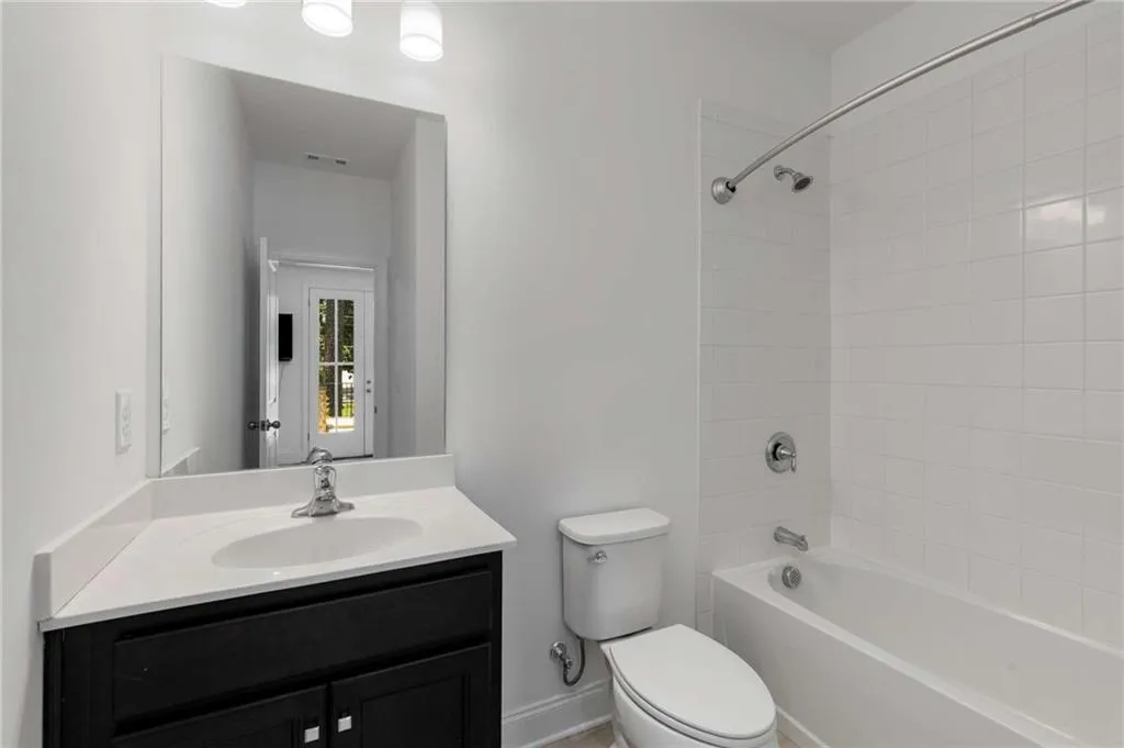 Bathroom featuring vanity and bathtub / shower combination