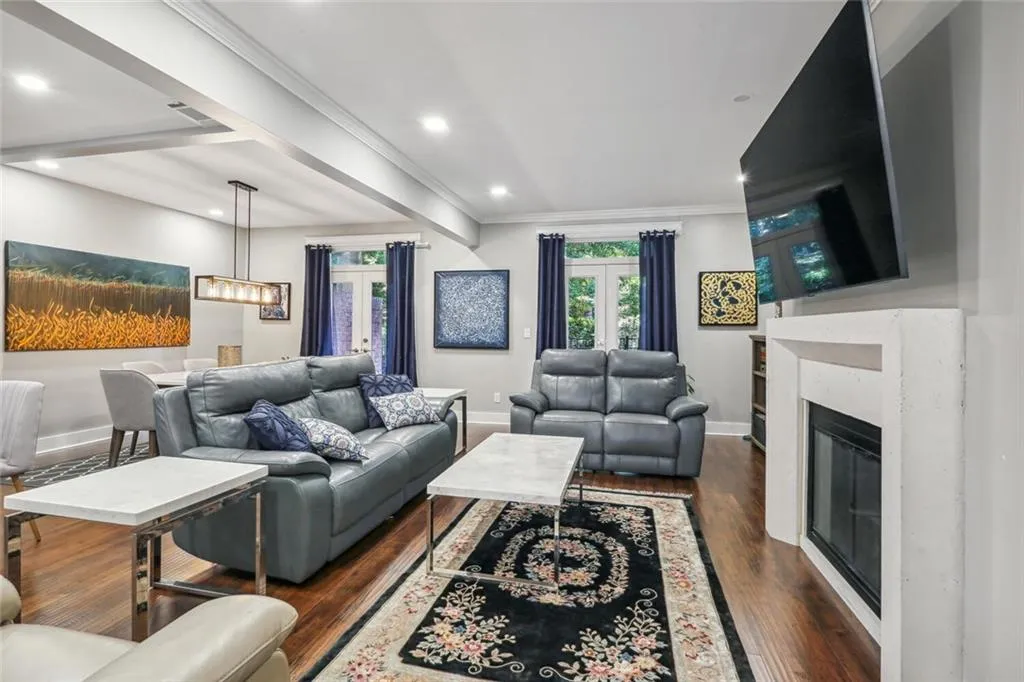 Living room featuring crown molding and dark hardwood / wood-style floors
