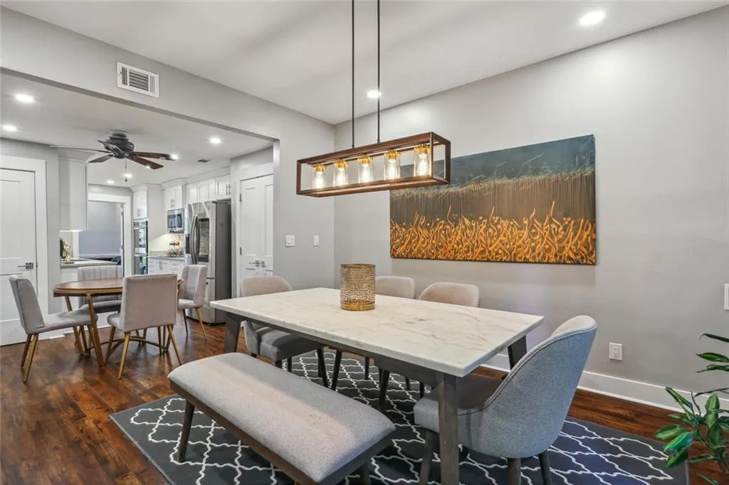 Dining space with dark hardwood / wood-style floors and ceiling fan