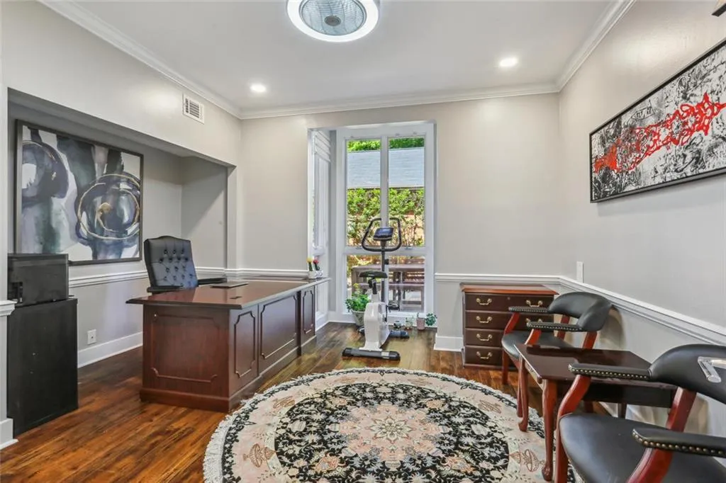 Home office featuring ornamental molding and dark hardwood / wood-style flooring