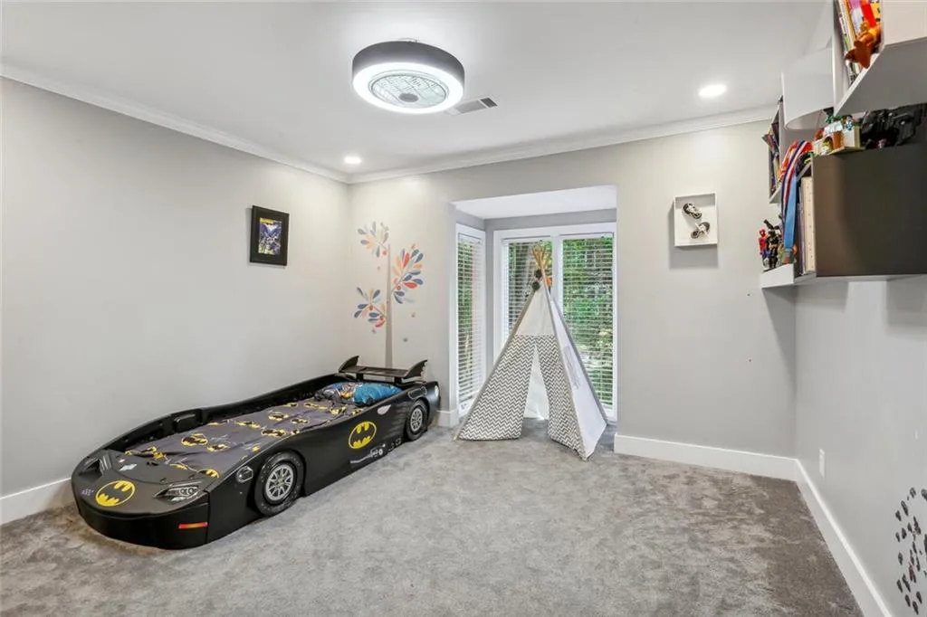Bedroom with ornamental molding and carpet