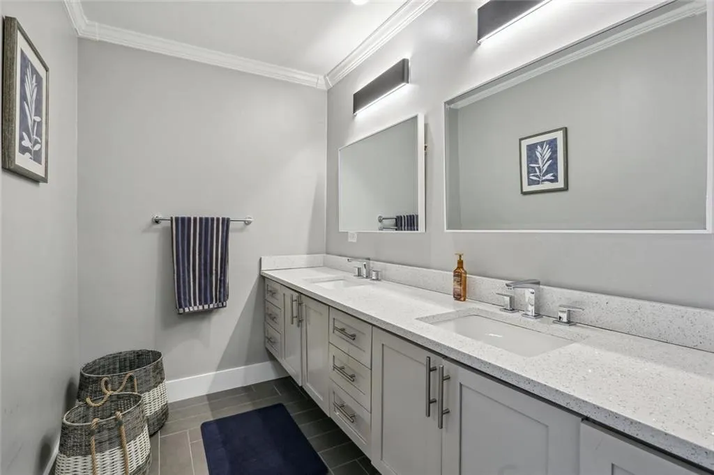 Bathroom featuring crown molding and vanity