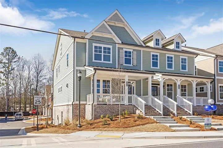 View of front of property with a porch and brick siding
