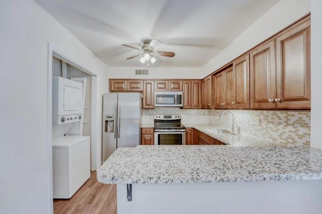 Kitchen including stack washer/dryer
