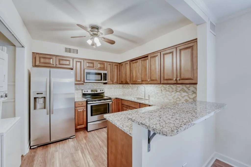 Updated kitchen featuring beautiful wood cabinets, granite counters & stainless steel appliances
