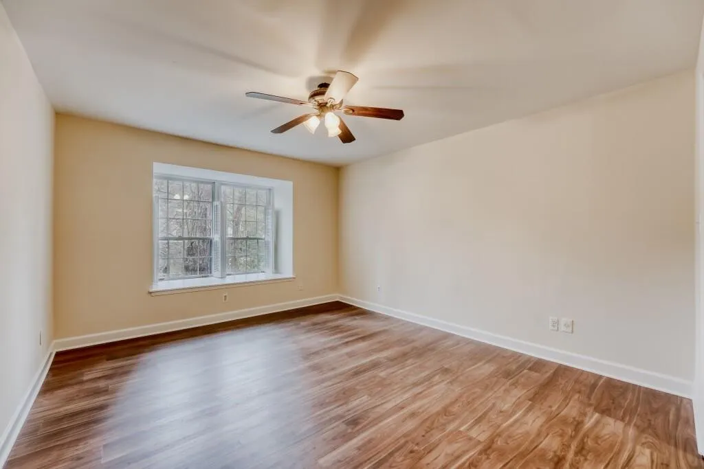 Master bedroom featuring wood finished floors and a ceiling fan