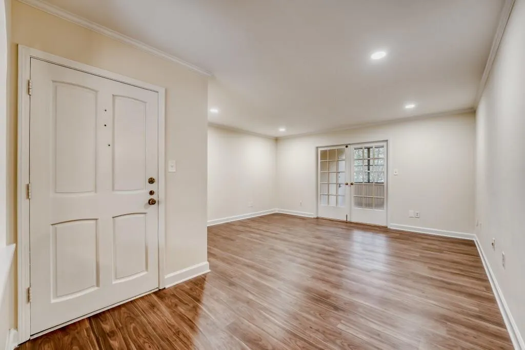 Foyer entrance featuring light wood-style floors, crown molding, french doors, and recessed lighting