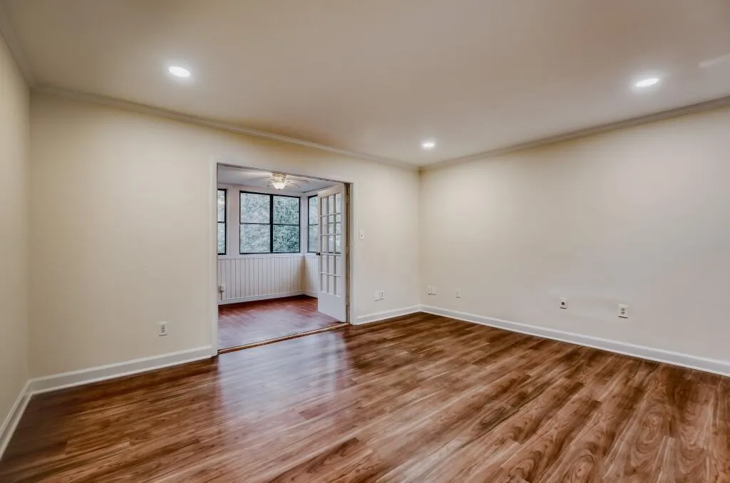 Great room with wood finished floors, crown molding, a ceiling fan, recessed lighting
