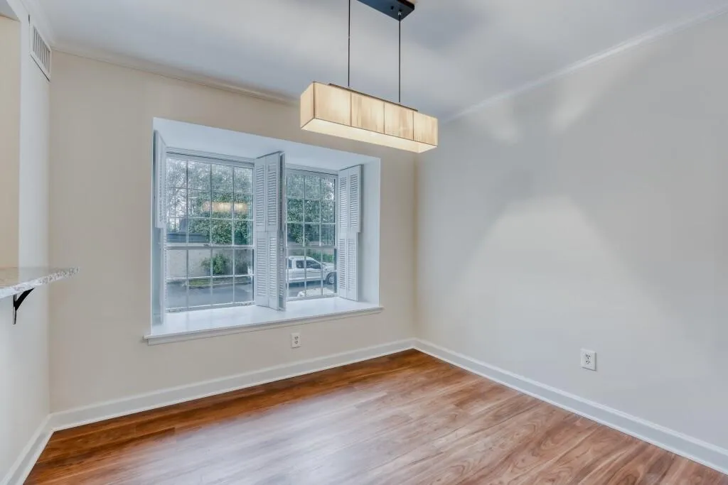 Formal Dining Room featuring ornamental molding and wood finished floors