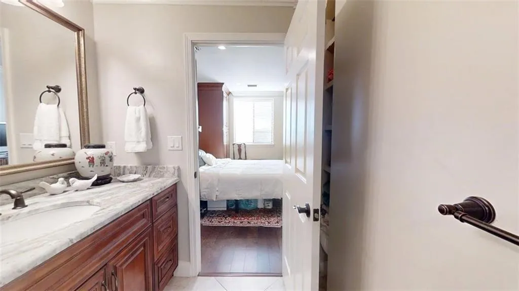 Ensuite bathroom featuring vanity and tile patterned floors