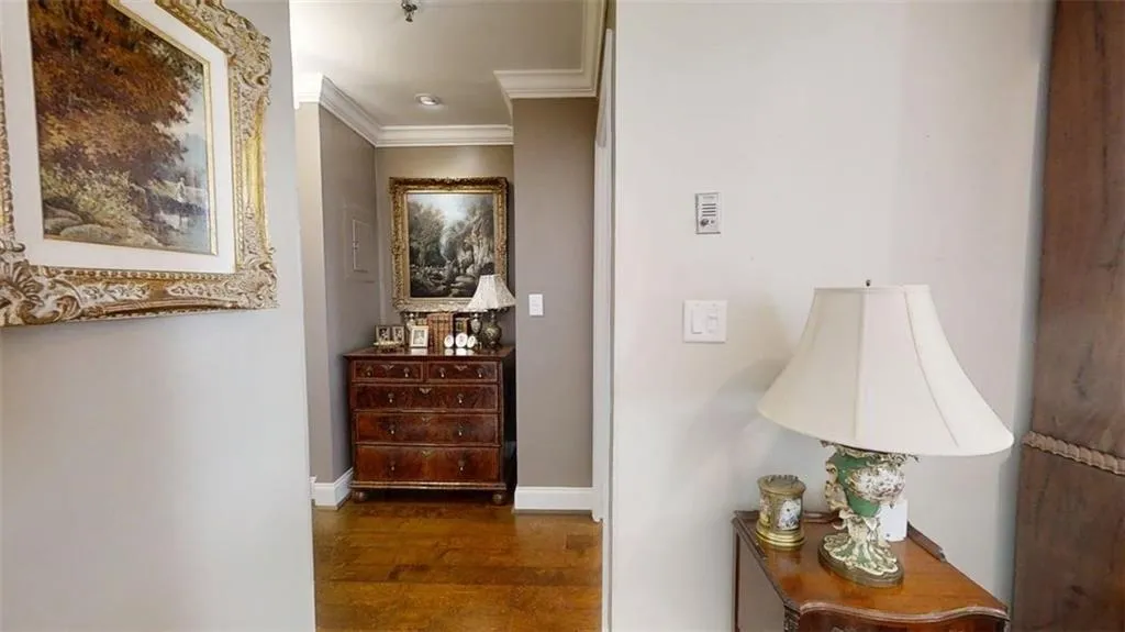 Hall featuring crown molding and wood finished floors