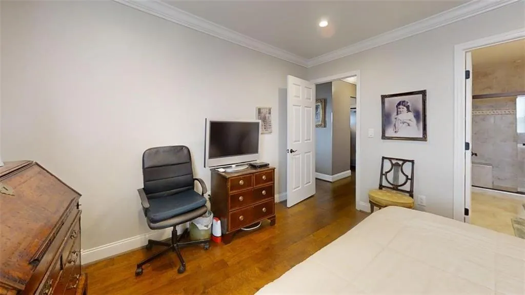 Bedroom featuring wood finished floors, ornamental molding, and recessed lighting