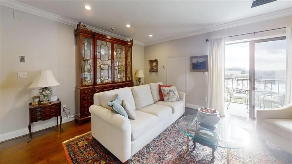 Living room featuring recessed lighting, ornamental molding, and wood finished floors