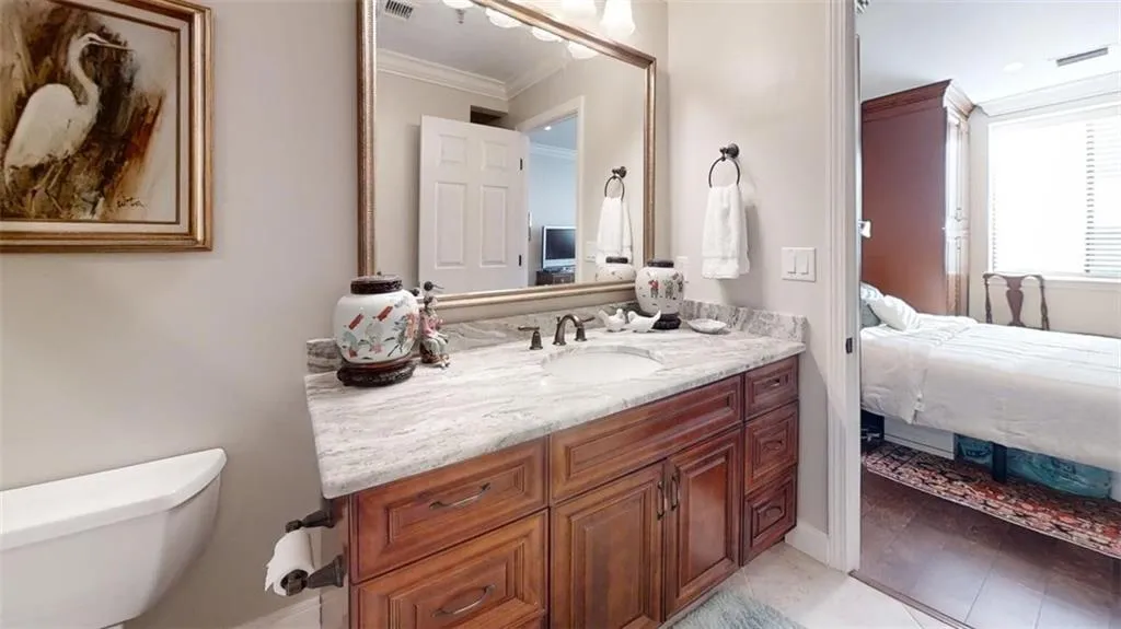 Ensuite bathroom with vanity and crown molding