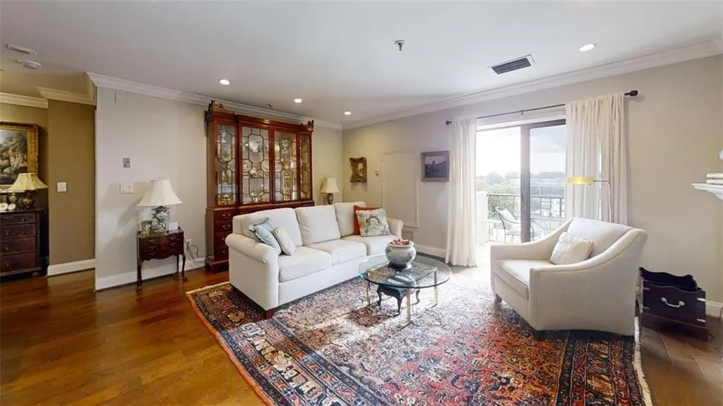 Living room featuring wood finished floors, recessed lighting, and crown molding