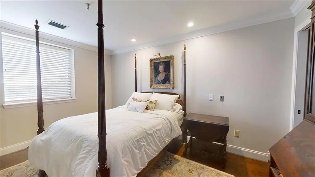 Bedroom featuring crown molding, recessed lighting, and wood finished floors