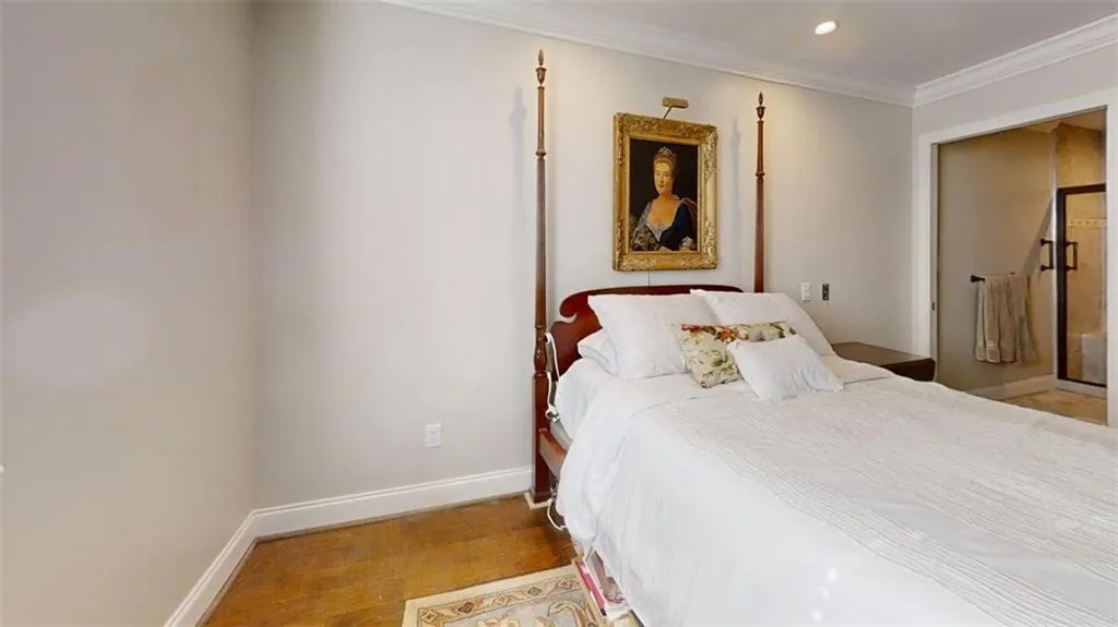 Bedroom with ornamental molding, wood finished floors, and recessed lighting