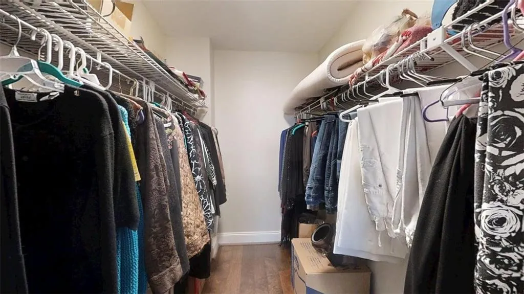 Spacious closet featuring wood finished floors